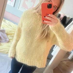 Gul stickad tröja - Mysig gul stickad tröja med långärmad design. Perfekt för kyligare dagar med sin fluffiga och bekväma känsla. Enkel och stilren, passar till många olika outfits.