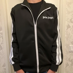 Svart track jacket från Palm Angels - Säljer denna jätte snygga tröja från Palm Angels. Den är använd fåtal gånger och är i bra skick. Storleken är M. Priset är ej hugget i sten.