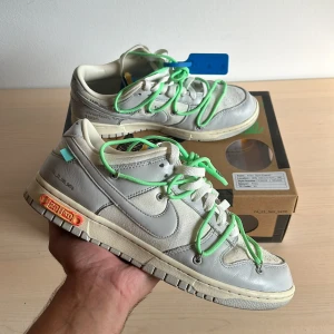 Off White - Dunk low LOT 26 - Säljer ett par Off White - Dunk lows LOT 26  Skorna är använda fåtal gånger och i perfekt skick  Storlek på skorna är EU 43 och US 9.5 Skorna är 100% äkta , kvitto från första köparen finns i lådan och det finns en legit check på appen CheckCheck 