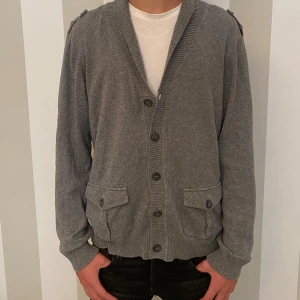 Cardigan  - Grå cardigan med knappar modellen är 172 och väger 56kg