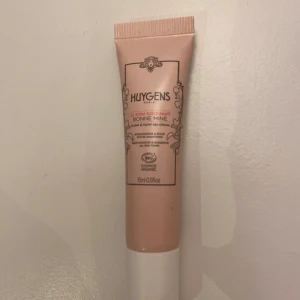 Huygens Bonne Mine Glow Cream - Huygens Bonne Mine Glow Cream i en ljusrosa tub. Denna kräm är ekologisk och designad för att ge huden en naturlig lyster. Perfekt för daglig användning för att återfukta och fräscha upp huden.