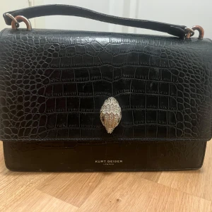 Kurt geiger väska - Svart Kurt geiger väska. Defekter: tappat färg på vissa silvriga delar. 