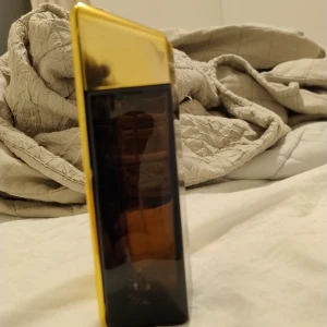 Guld Parfymflaska 1 Million - Säljer en lyxig parfymflaska i guld från Paco Rabanne, modellen 1 Million 70 ml kvar ungefär, Flaskan har en elegant och modern design med en mörk glasdel och en gyllene framsida. Perfekt för den som vill ha en doft som sticker ut och ger en känsla av exklusivitet.