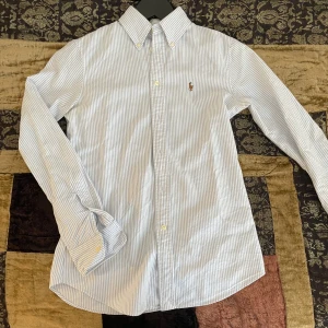 Ralph lauren custom fit skjorta - Tja, säljer pga att den är lite liten på mig.  Storlek Xs passar 160-170. Toppen skick 9,5/10, inga defekter jag vet om. Knappt använd. Hör av er vid minsta lilla fråga.