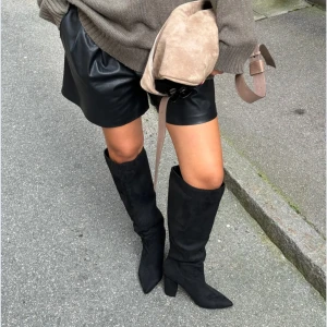 Svarta höga stövlar från Nelly - Snygga svarta höga stövlar från Nelly i mocka med spetsig tå och klack. Endast använda två gånger. Helt slutsålda överallt🥰original priset är 800kr 