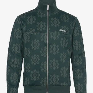 Mönstrad grön jacka från Les Deux - Snygg grön jacka från Les Deux med ett unikt mönster. Jackan har dragkedja framtill och en hög krage. Perfekt för att ge din outfit en stilfull touch. Nypris 1700kr. Les Deux Ballier Jacquard Track Jacket