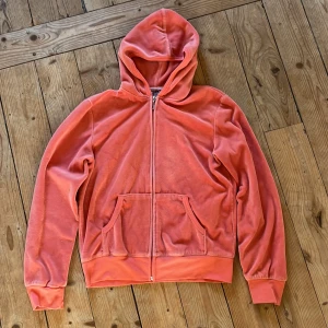 Rosa hoodie från Juicy Couture - Säljer en snygg rosa hoodie från Juicy Couture. Tröjan har ett glittrigt mönster med en krona och bokstäver på ryggen. Den saknar tyvärr några glitterpluppar men i mitt tycke är det inget som stör. Den är även lite nopprig inut i men det är ju inte som syns när man har den på sig och inget som stör heller jag tycker att den är jätteskön och fin men den kommer dessvärre inte till användning längre💓💓Det står även att den är i xxl men det är den inte jag har vanligt vis xs och den sitter jättebra!