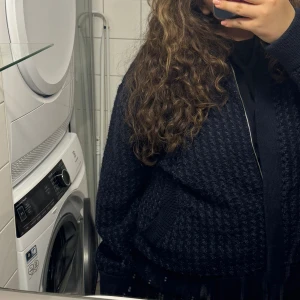 Mörkblå stickad bomberjacka  - Säljer en snygg mörkblå stickad bomberjacka. Köpt på Mango och är enkel att styla, stilren och fickor framtil. Den har inga defekter och är i nyskick.