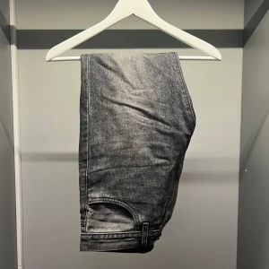 Grå jeans från Levi's - Snygga grå jeans från Levi's med klassisk design. Perfekta för en stilren look. Märkeslappen på baksidan ger en autentisk touch.