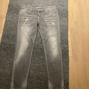 Grå jeansbyxor Dsquared - Säljer ett par Gråa Jeans med feta slitningar från Dsquared. De köptes för 2100 på vinted och säljs nu pga att de är för små. Storlek L 32 W 32. Vid snabb affär så är priset förhandlingsbart