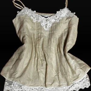 Beige randig linne från Atmosphere - Säljer ett superfint beige linne från Atmosphere med vita spetsdetaljer. Linnet har smala axelband och ett vackert randigt mönster. Perfekt för sommardagar eller en avslappnad vårlook. 🕊️ den passar ej mig så säljer, den är lite stor på mig.