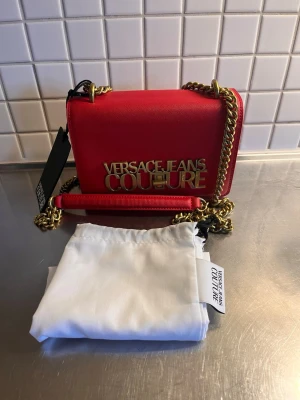 Väska  - Röd väska i mycket fint skick. Köpt hos Zalando, kvitto finns om så önskas. 