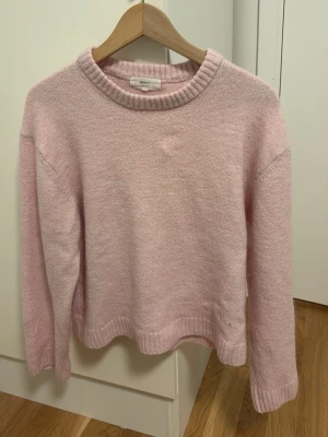 Ljusrosa stickad tröja - Mysig ljusrosa stickad tröja från Gina Tricot i ullblandning. Tröjan har rund halsringning, ribbade muddar och lång ärm. Perfekt för lager på lager under kyliga dagar. Passar till jeans eller kjol. Skriv gärna ifall ni skulle vilja ha fler bilder. Pris går att diskutera.