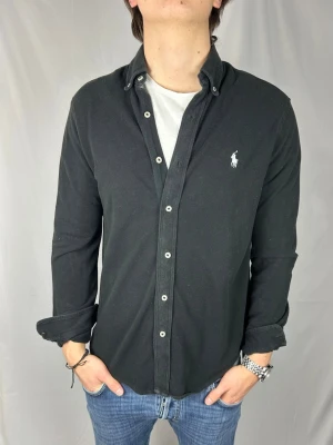 Ralph Lauren Featherweight skjorta - Säljer nu denna snygga och sköna ”featherweight mesh” skjortan.                          Size: M, passar M/L Skick: 9/10, väldigt bra utan märkbara defekter. Retail pris: 2500kr (+). Modellen är 185cm och väger 78kg. Hör av dig vid frågor eller funderingar!