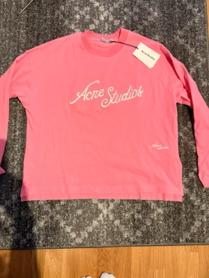 Rosa långärmad topp Acne Studios - Säljer en rosa långärmad topp från Acne Studios med vit logga framtill. Aldrig använd, taggen finns kvar men avklippt 🩷