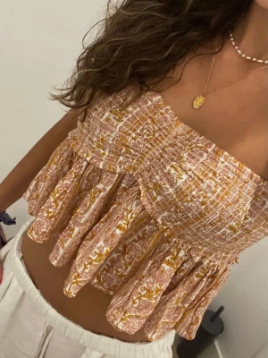 Mönstrad topp - Supersöt mönstrad topp i ljusrosa och gul. Toppen har volanger och smockad överdel. Den är helt oanvänd 💞