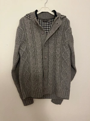 Cardigan - Hej nu säljer vi denna grymt feta Olly Gan fodrade cardigan i en stilren grå färg som lätt gör att klä sig bra i. Skicket 9/10 inga defekter. Storleken: (4)≈M/L Bröstlängd: 50cm. Midjalängd: 50cm. Längd:65cm. Armlängd: 65cm. För fler frågor hör gärna av er så hörs vi!