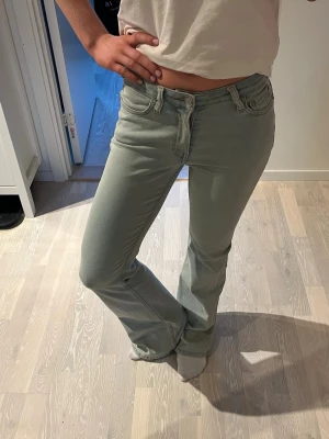 Ljusblå bootcut jeans - Säljer ett par lågmidjade ljusblå bootcut jeans med klassisk femficksdesign. Jeansen har en snygg utsvängd passform. Materialet är mjukt och stretchigt. Skriv för mått