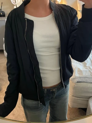 Svart bomberjacka - Säljer en mörkblå bomberjacka Ellos i storken 38