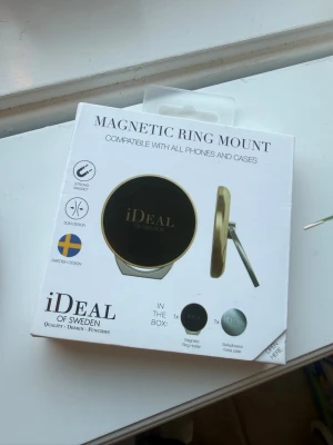 Magnetisk ringfäste iDeal of Sweden mässing/roséguld  - Snyggt magnetiskt ringfäste från iDeal of Sweden i guld och svart. Passar alla mobiltelefoner och skal. Slimmad design med svensk stil, perfekt för att hålla mobilen säkert och smidigt i handen eller ställa upp den på bordet. Nypris 300:- 