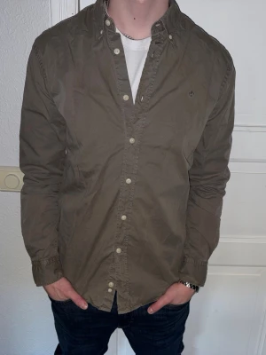 Olivgrön skjorta från Morris - Olivgrön skjorta från Morris i storlek M.  Fint skick till ett bra pris. Nypris: 1995kr. Mitt pris: 349kr. Vid frågor eller funderingar, tveka inte att höra av dig.