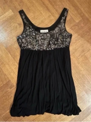 Cocktail klänning - Jättesnygg svart cocktail klänning från PARIS KATE AND I. Klänningen är svart med paljettdetaljer runt bysten och ballong slut. Storlek S