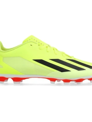 Adidas gula fotbollsskor med svarta ränder - Snygga fotbollsskor från Adidas i neon-gult med klassiska svarta ränder på sidan. Skorna har låg profil, snörning och en yttersula med röda och vita dobbar för bra grepp på planen. Perfekta för dig som vill sticka ut på matchen.