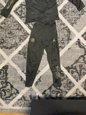 Svart PSG träningsset Jordan x Qatar - Psg träningssätt, knappt använd. Säljer eftersom att jag har vuxit ut. M men passar S. Enda defekterna är att den har tappat lite färg på texten. Prutning vid snabbköp.