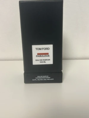 Tom Ford Fabulous Eau de Parfum 100 ml - Tom Ford Fabulous Eau de Parfum i en elegant svart flaska med vit etikett och tydlig logga. Flaskan har en unik, fyrkantig form och rymmer 100 ml. Doften är exklusiv och flaskan känns lyxig och modern – perfekt för dig som gillar stilrena detaljer.