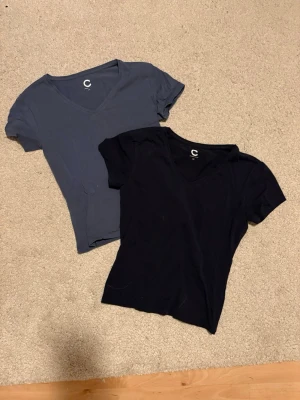 Två basic V-ringade t-shirts - Säljer två stilrena t-shirts från Cubus i marinblå och mellanblå. Båda har V-ringning och korta ärmar. Perfekta till jeans eller shorts och tillverkade i mjukt bomullsmaterial för skön känsla hela dagen.