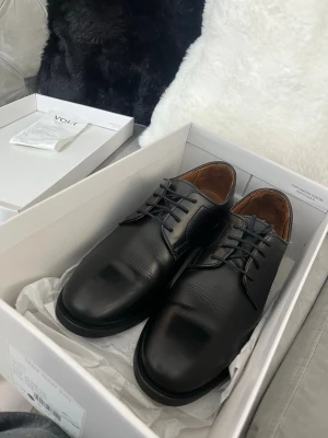 Svarta loafers från Volt - Äkta läder skor från volt för 1200 (pris kan diskuteras) , original pris: 1600kr, storlek 40 passar jätte bra för studenter, fester, bröllop osv använda bara en gång ska sälja den för behöver pengar inga skador eller fläck på skorna helt nya med kvitto kartong och påse. 