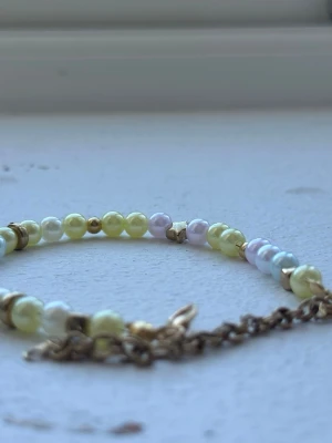Handmade bracelet  - This is a handmade bracelet by myself, with yellow, white, purple and pink pearls. It has gold beads/cubes between some and a star. Beautiful bracelet to wear whenever, with an adjustable part so you can make it bigger or smaller. Check out my profile for more handmade pieces 🌸