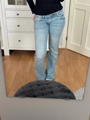 Ljusblå bootcut jeans med brodyr - Säljer ett par ljusblå bootcut jeans med snygg broderad detalj på bakfickan. 