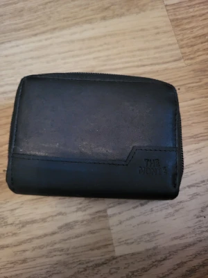 Practical wallet - Practical black wallet that is RFID safe. 9 card/cash slots, one coin pocket. One of the card slots has a hole on one side. The wallet as a whole shows signs of wear with scuffs etc.  Bundle discounts: two items 5% off (automatic) three items 10% off, five items 20% off. Message me before purchasing 3+ items for discount.