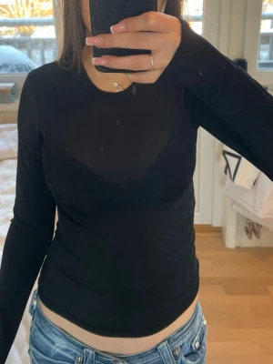 Svart långärmad  - Svart långärmad tröja från carin wester. Är i något material som blir lite genomskinligt och den ser lite ribbad ut. Pris kan absolut diskuteras men är ganska säker på att den kosta runt 400 när jag köpte🥰