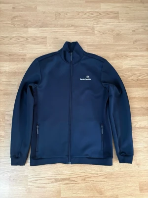 Sergio Tacchini Kofta - Säljer denna då den inte längre används  Märke - Sergio Tacchini   Storlek - XL  Sitter mer som M/L  Längd - 74cm Armhåla till armhåla - 55cm Ärmlängd - 53cm  Pris går att diskuteras