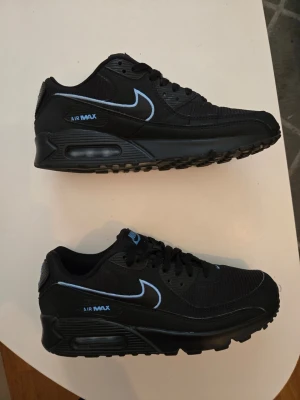 Nike Air Max 90 svart/blå sneakers - Ett par orginal skor från nike, Air max 90. Använd någon enstaka gång så som helt nya
