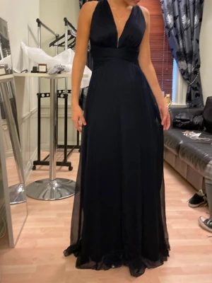 Marinblå klänning!! - Elegant marinblå långklänning med djup v-ringning. Klänningen är perfekt till bal, eller andra eleganta tillställningar!! Endast använd 1 gång. Har lite skador längst ner på klänningen men inget som syns!!💙