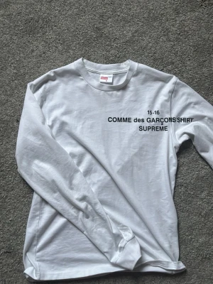 Vit långärmad Supreme x Comme des Garçons - Säljer en clean vit långärmad t-shirt från Supreme och Comme des Garçons. Endast använd 3 gånger, passar till allt. Priset är inte hugget i sten
