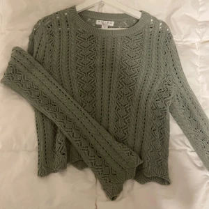 Grön stickad tröja från Amisu - Säljer en superfin grön stickad tröja från Amisu. Den har ett snyggt hålmönster och långa ärmar. Perfekt för höst och vår när du vill vara både stilren och bekväm. Tröjan är i bra skick och passar perfekt till jeans eller kjol. 🌿