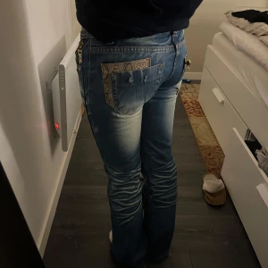Lågmidjade jeans - Säljer dessa jeans med låg midja och snygga detaljer, storlek: ca XS, midjemått: ca 37cm! De är utsvängda där nere💙 Pris kan diskuteras