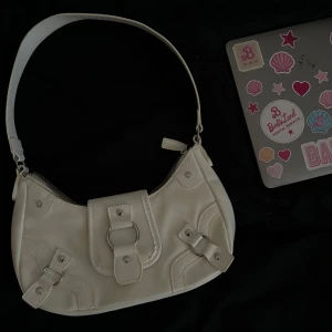 Vit väska - En vit väska, super fin och nyskick. Kommer dock inte till användning alls så lika bra o se om nån är intresserad. Tror den är köpt på hm.