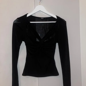 Svart långärmad topp från Bik Bok - Snygg svart långärmad topp från Bik Bok med en djup v-ringning och rynkade detaljer framtill.