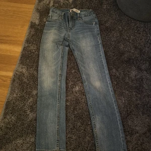 Blå jeans från Levi Strauss & Co. - Snygga blå jeans från Levi Strauss & Co. med klassisk femficksdesign och en bekväm passform. Perfekta för en avslappnad stil. Märkeslappen på baksidan ger en autentisk touch.