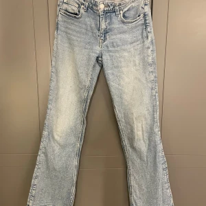 Ljusblå jeans från Gina Tricot - Säljer ett par ljusblå jeans från Gina Tricot. De har en klassisk femficksdesign och är tillverkade i denim. Perfekta för en avslappnad stil.