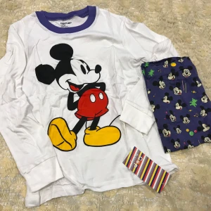 Barn Musse Pigg tröja med Byxor  - Säljer en söt vit långärmad tröja från BabyGap med en stor bild av Musse Pigg på framsidan. Tröjan har en blå krage och är perfekt för små Disney-fans. Finns i storlekar kvar 2 - 7  år.  145kr/paket 