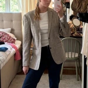 Beige ”linne”kavaj - Snygg beige kavaj i linneliknande material. Köpt secondhand och har därav ingen storlek men passar allt mellan XS-L beroende på hur man vill ha passformen. Super fint skick, inga skavanker! ☺️