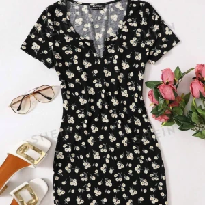 blommig klänning - svart blommig klänning, slutar strax ovanför knäna. 