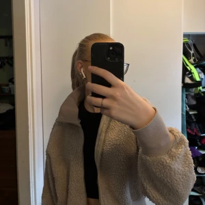 Beige teddyjacka från Bik Bok - Mysig beige teddyjacka från Bik Bok med dragkedja framtill. Jackan har ribbade muddar vid ärmslut och nederkant, vilket ger en skön passform. Perfekt för kyligare dagar. Använd fåtal gånger!