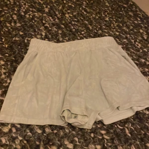 Ljusgröna shorts från Gina Tricot - Snygga ljusgröna shorts från Gina Tricot i en mjuk och bekväm design. Perfekta för varma dagar med en avslappnad passform och elastisk midja. Ett måste i garderoben för en stilren look.
